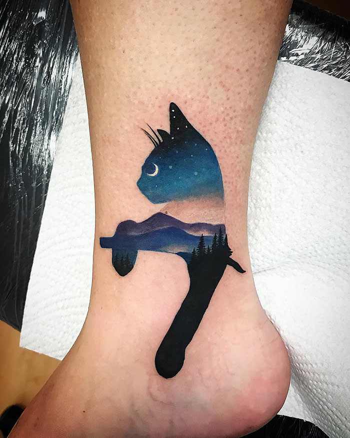 11 Tattoos of Cats with sky and stars on a black background moon landscape on calf