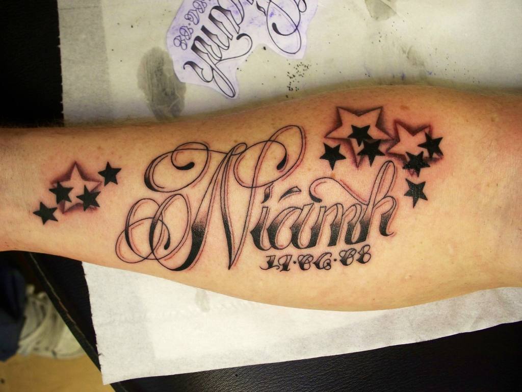 37 Fonts for Tattoos of Niamk Names with date stars and typology with shadow on forearm