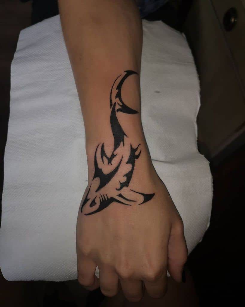 40 tatuaggi di squali tribali neri su mano e polso