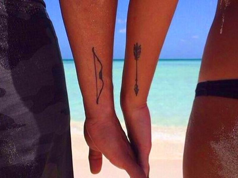 3 TOP 3 Small and complementary Tattoos for Couples on wrists in one bow in the other arrow