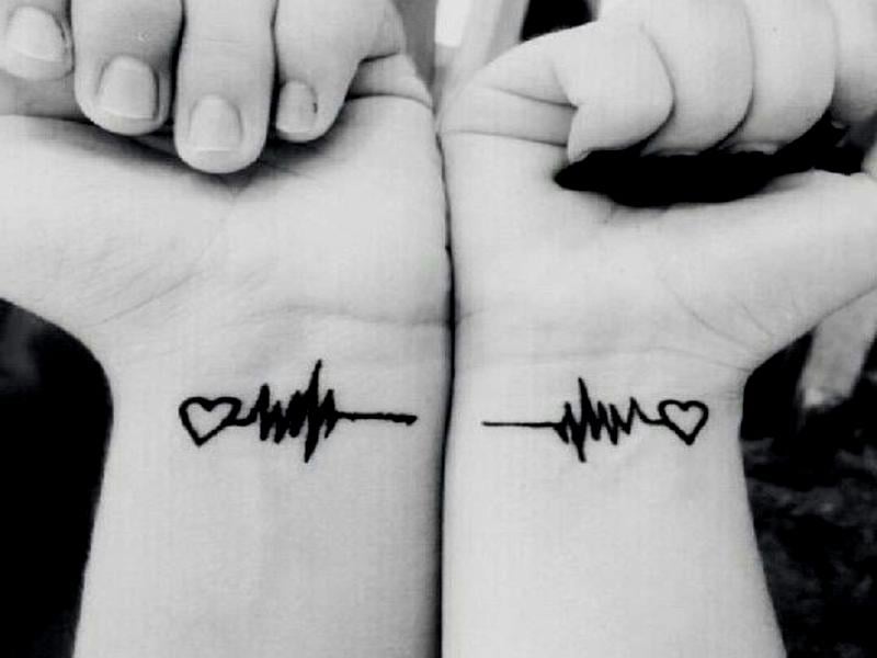 Small and complementary tattoos for couples on wrists Cardio and heart