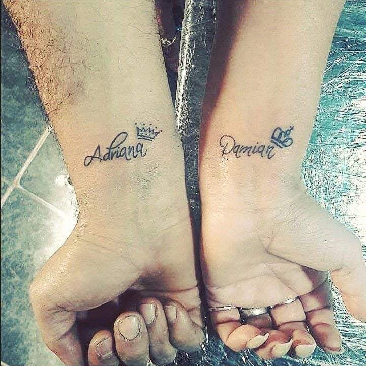 Small and complementary tattoos for couples on wrists Names Adriana and Damian with king and queen crowns