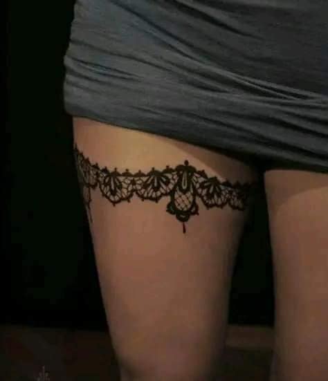 31 Garter Tattoos on the Thigh with ornaments around