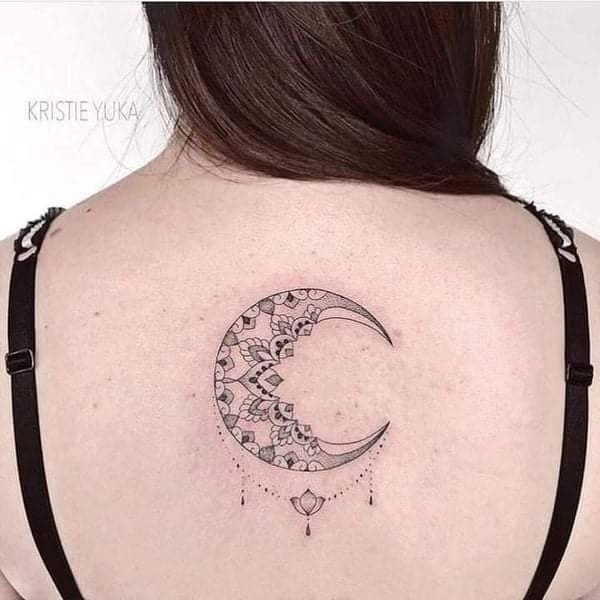 44 Tattoo Back Woman Half Moon with ornaments in the middle of the black shoulder blades