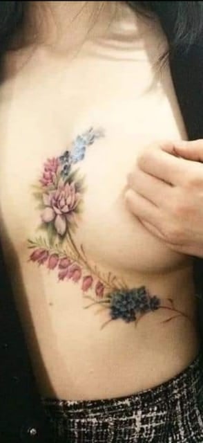13 Tattoos and a half of the Breasts Branches and Flowers in pink and blue tones