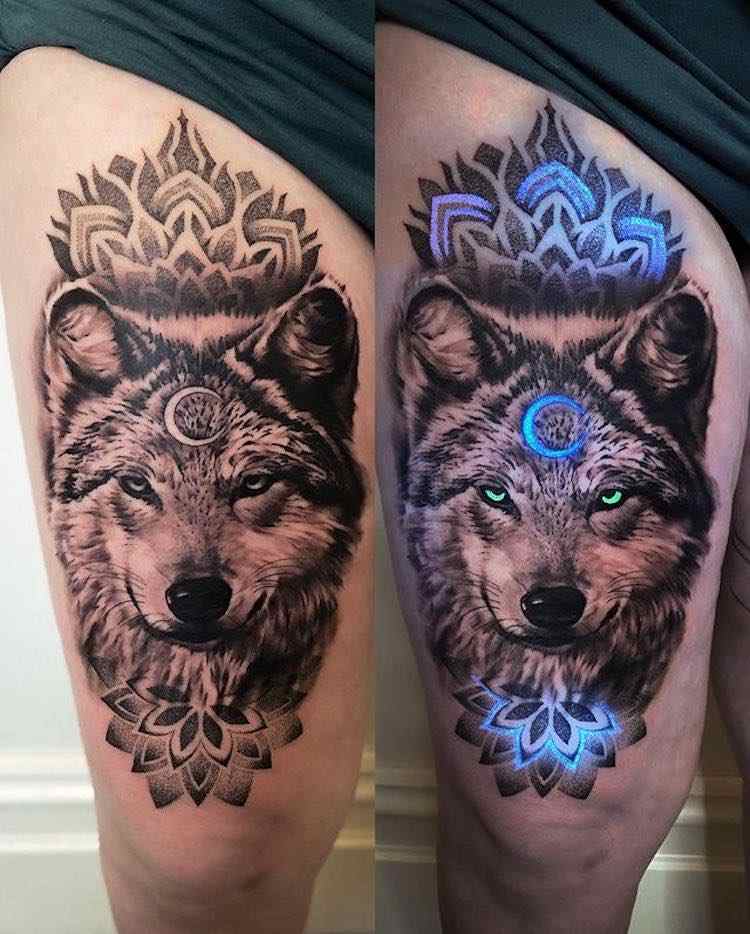 167 Tattoos with UV Ink wolf with lotus flower moon and blue luminescent eyes on thigh