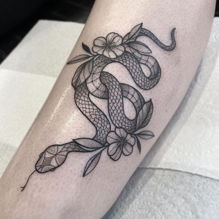 69 Tattoos of Black Contour Snakes with Flowers and Leaves coiled in itself 1