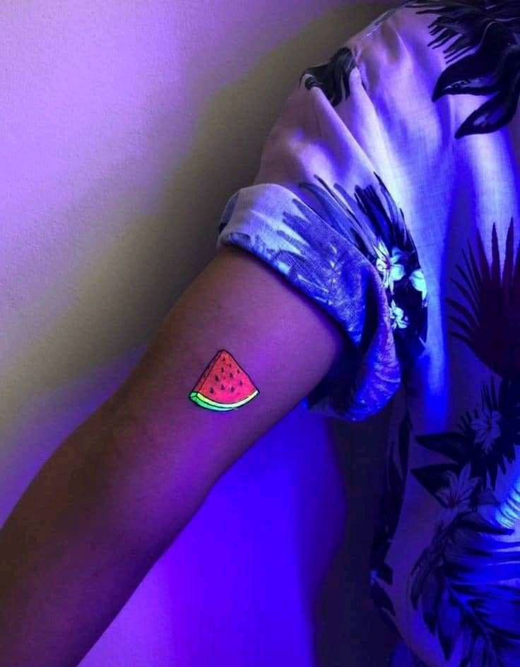 8 UV tattoos a quarter of a watermelon on the arm green and red