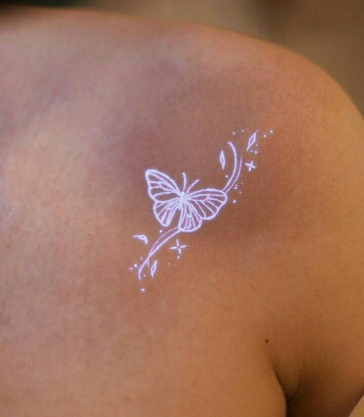 93 UV tattoos with white ink butterfly stars leaves on shoulder blade