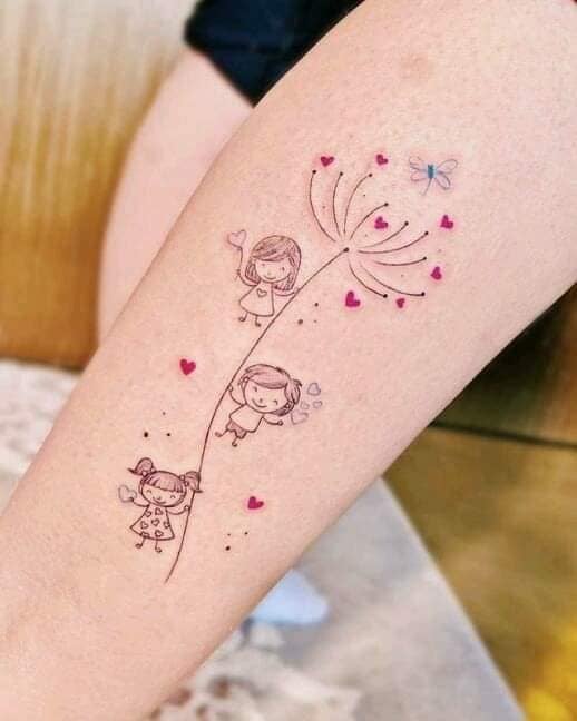 33 Tattoos of Mothers for Children Three Children holding onto a dandelion stem with small fuchsia hearts and a dragonfly on the forearm