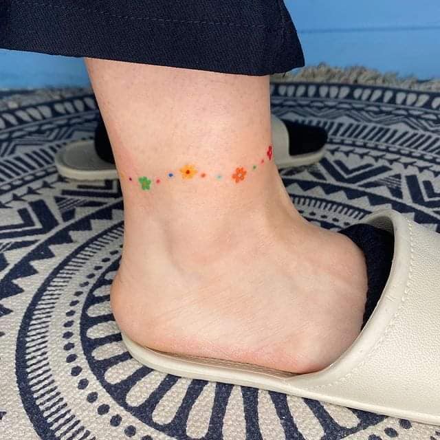 37 Small colored anklet tattoos of colored flowers