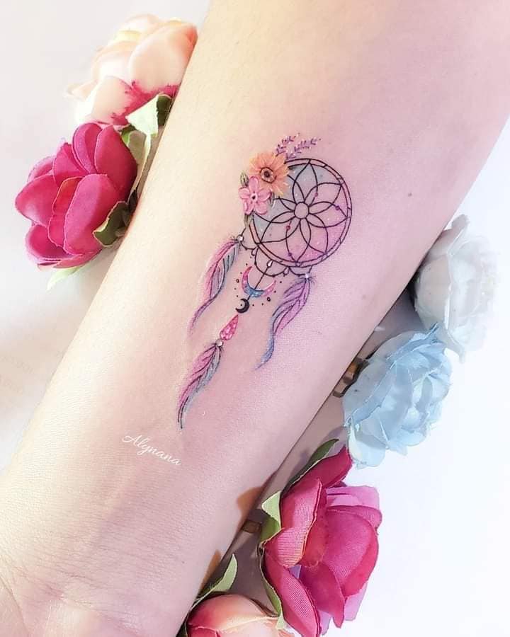 Beautiful Tattoos for Women Dreamcatcher with mandala in fine pink and violet tones on the wrist