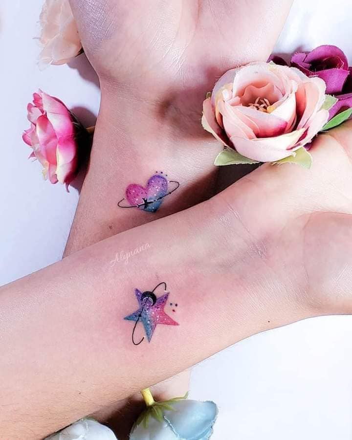 Beautiful Tattoos for Women in couples or sisters pink and violet heart and star with moon and plane on wrists