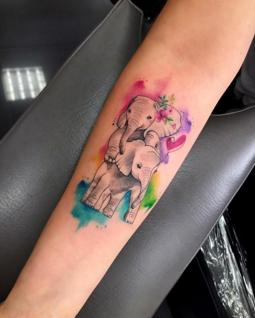Tattoos in Watercolor Mother Elephant with Little Elephant Son on forearm colors red light blue green yellow