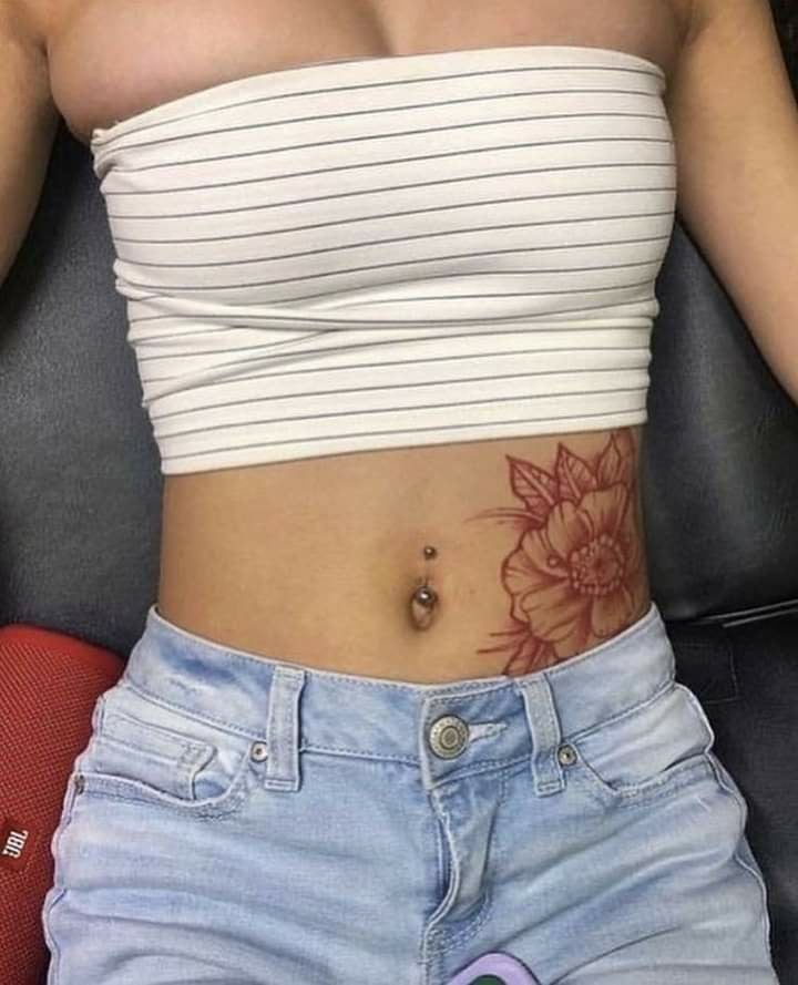18 Tattoos Abdomen Red Flower outline with leaves on the left side