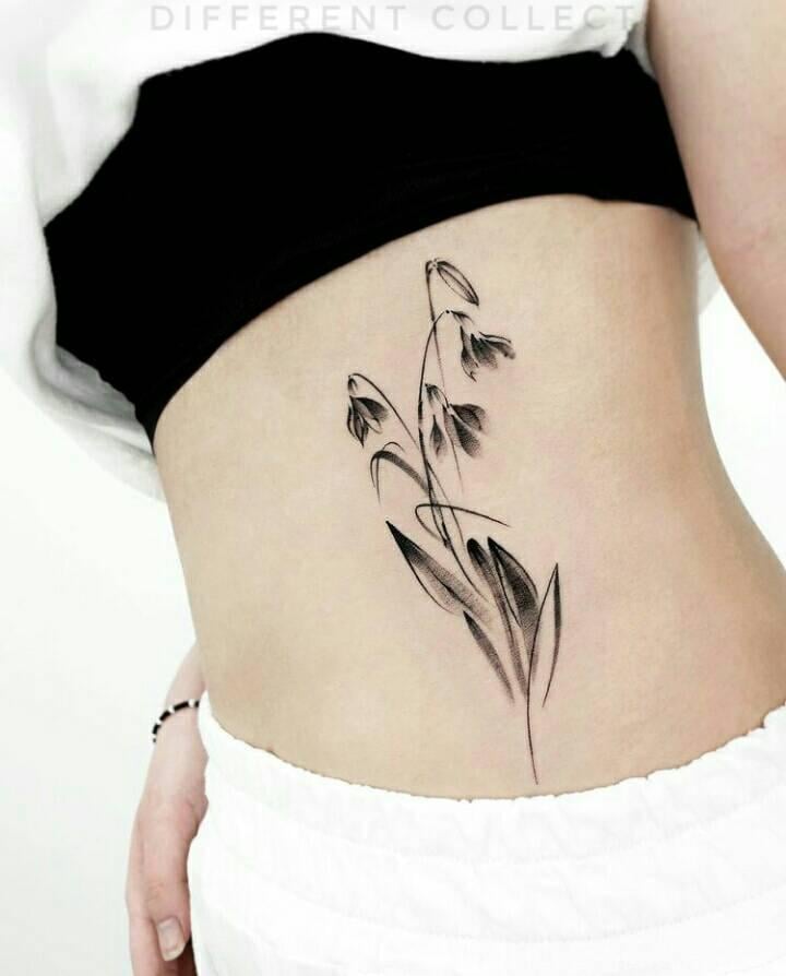 36 Tatouages sur l'abdomen Fleur noire avec tige et feuilles artistiques