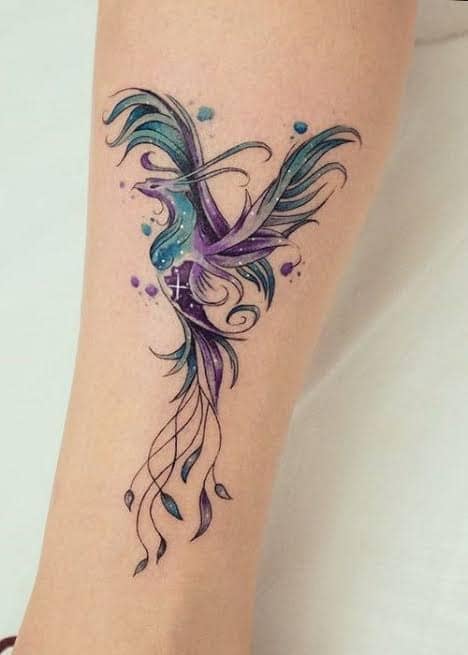 42 Phoenix Bird Tattoo sul polpaccio nei colori viola, azzurro e nero