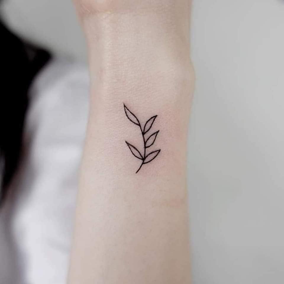 57 Small Aesthetic Tattoos outline of black twig on wrist