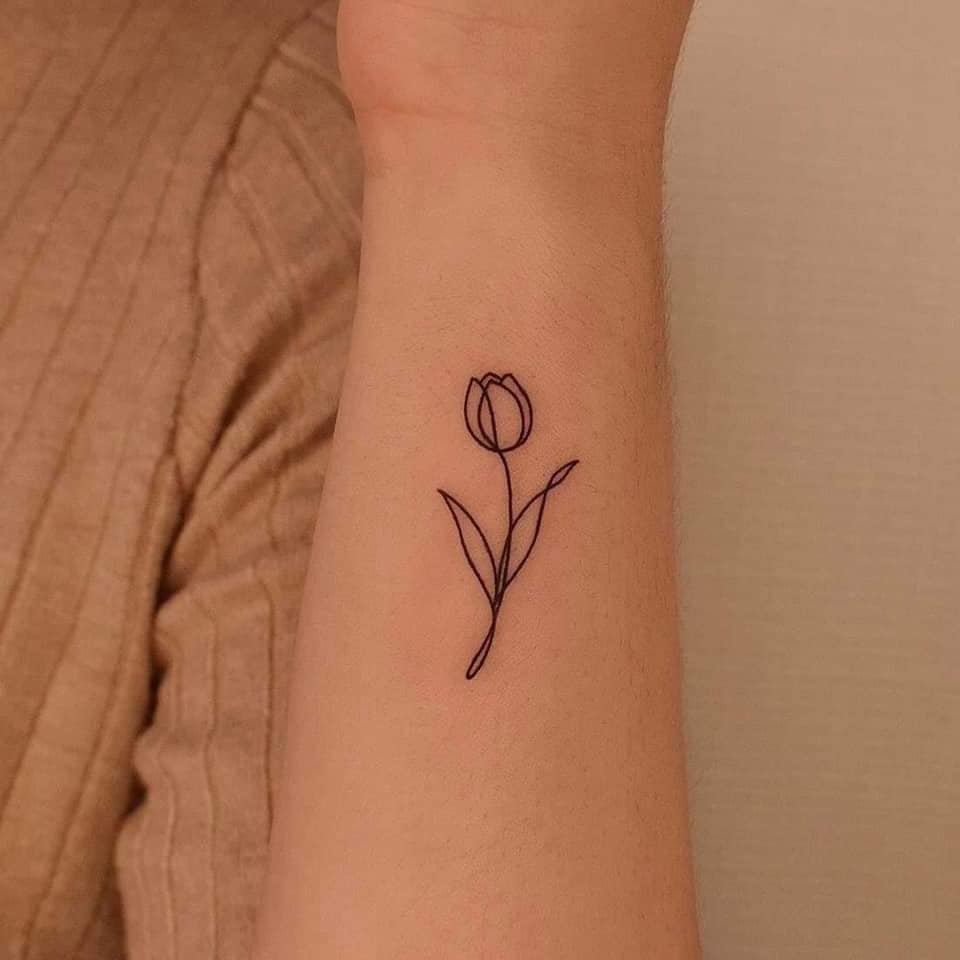 9 Small Minimalist Rose Tattoos in profile on the side of the forearm