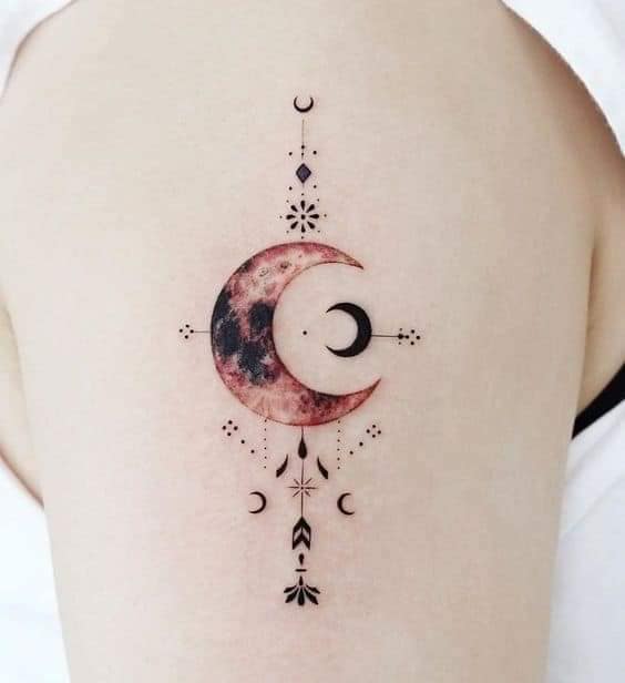 9 Moon tattoos on the arm moon with smaller crescents ornaments in fine black and center in red