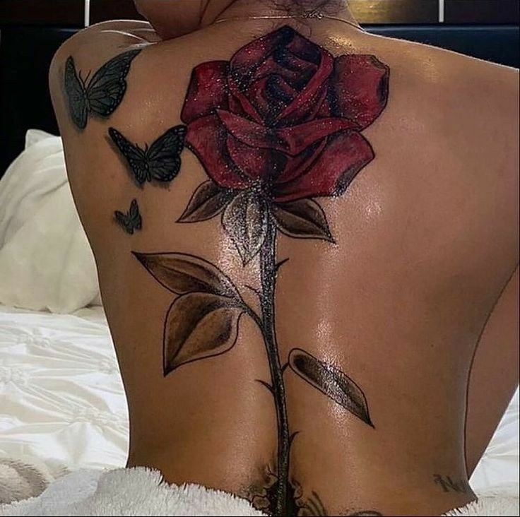 1 TOP 1 Tattoos on the Back of a Woman Large Red Rose with Stem on the black column Butterflies on the shoulder blade