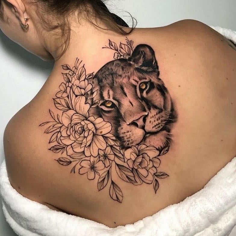 22 Tattoos on the Back Lioness looking Front Black Flowers on the upper half of the back in black