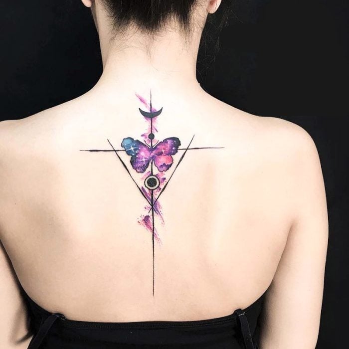 28 Tattoos on Woman's Back Triangle lines circles moon and butterfly in watercolor with purple universe in the middle of the shoulder blades