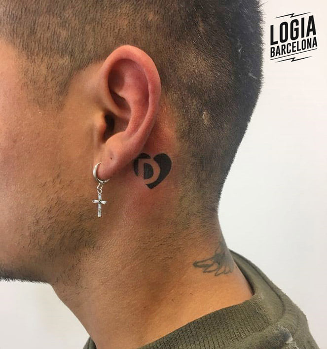 37 Tattoos behind the ear heart with letter D inside in negative