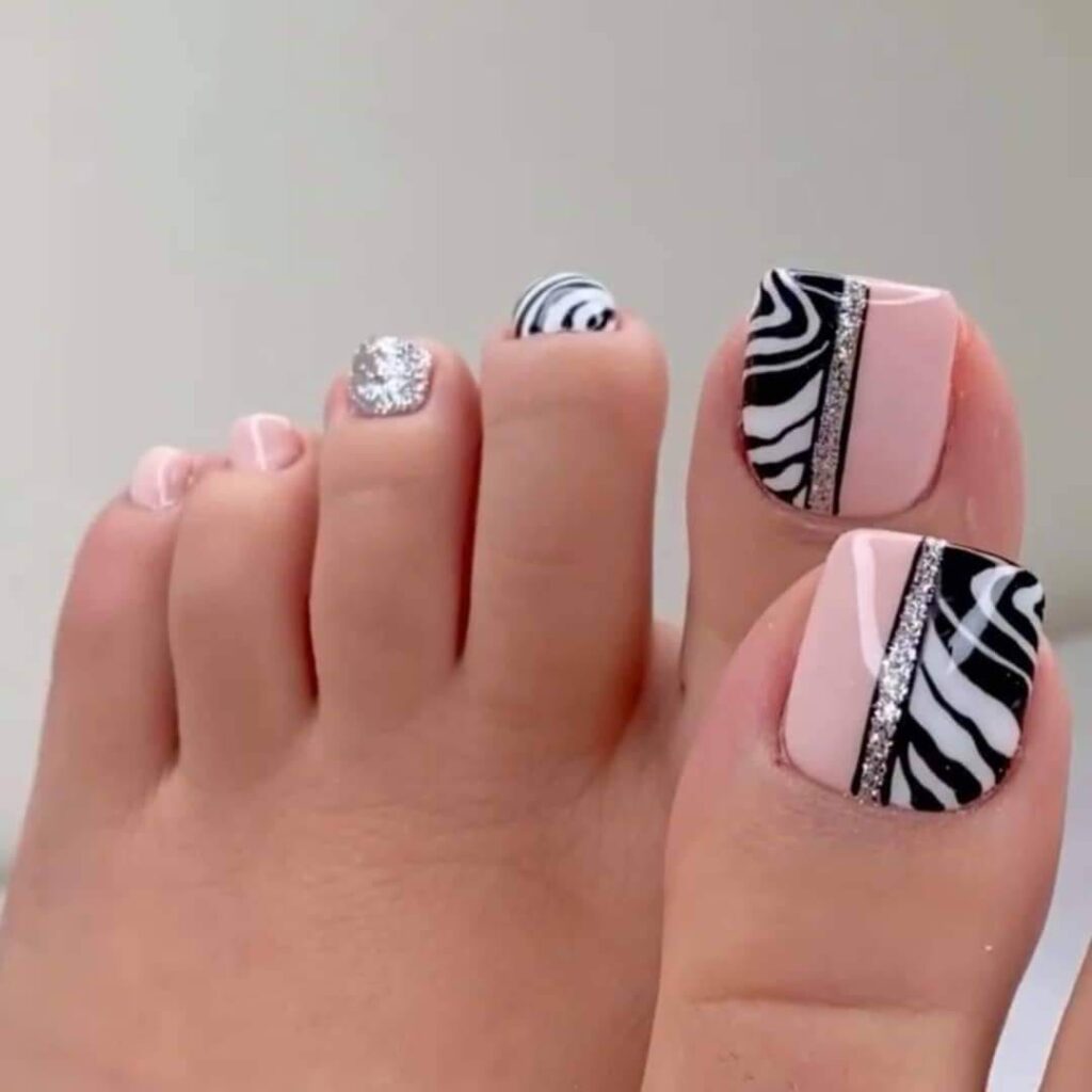 91 Unas de los pies decoradas con dibujo de animal print blanco y negro y linea de brillante plateado