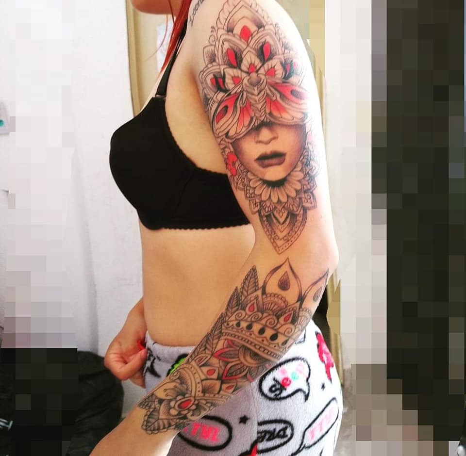 Most liked Women's tattoos Full sleeve tribal motifs mixed with mandala woman's face in red and black