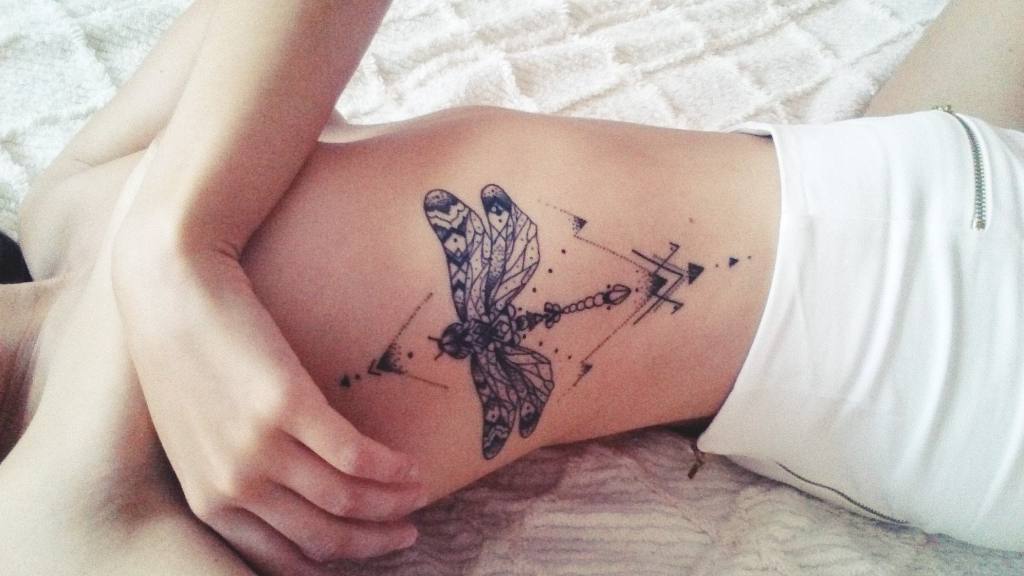 Large Dragonfly tattoos on the entire left rib