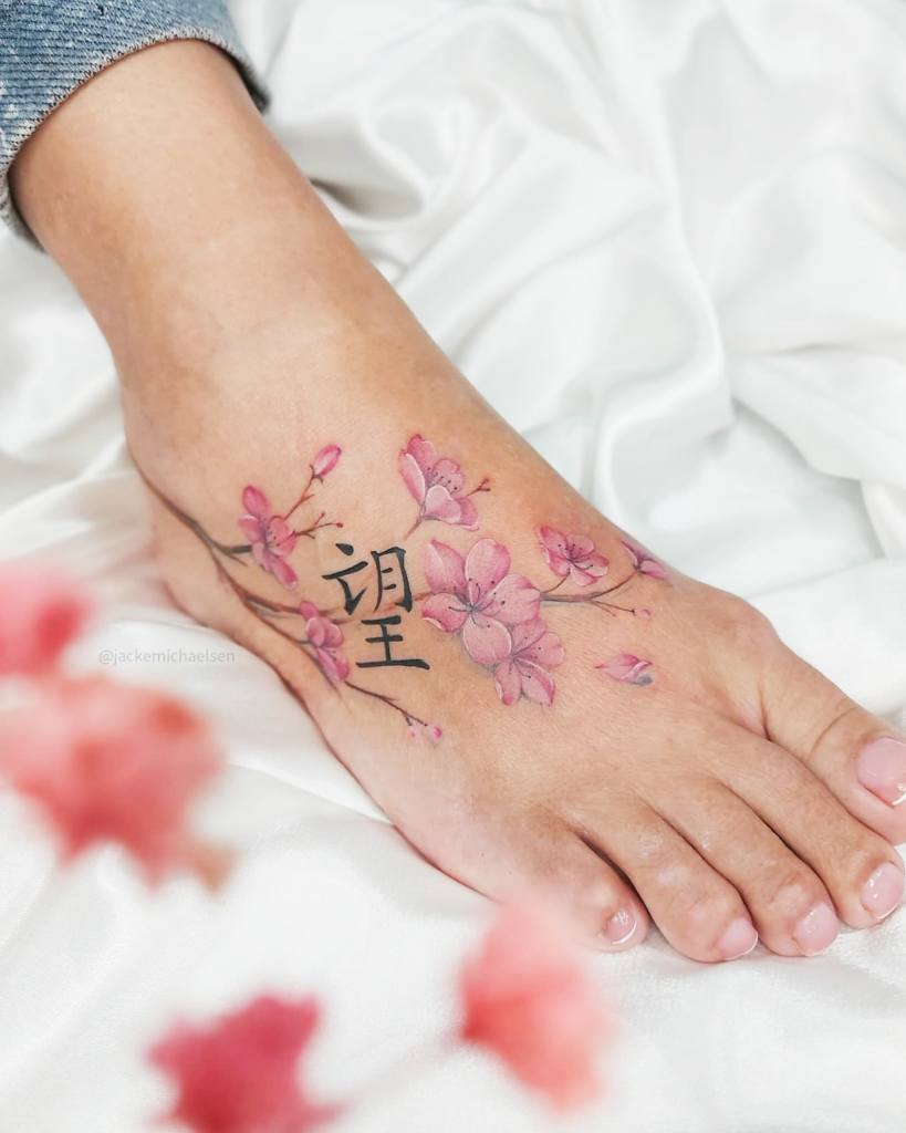 22 Artist Jacke Michaelsen BR Tattoos Cherry Blossoms with Branch and Chinese Letter on Foot