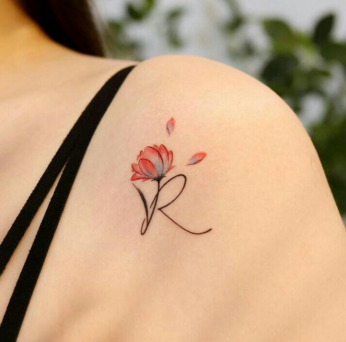 28 Delicate tattoos initial letter R with red and light blue flower petals on shoulder