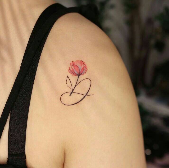34 Delicate tattoos initial letter d with fine lines and small red flower on the shoulder