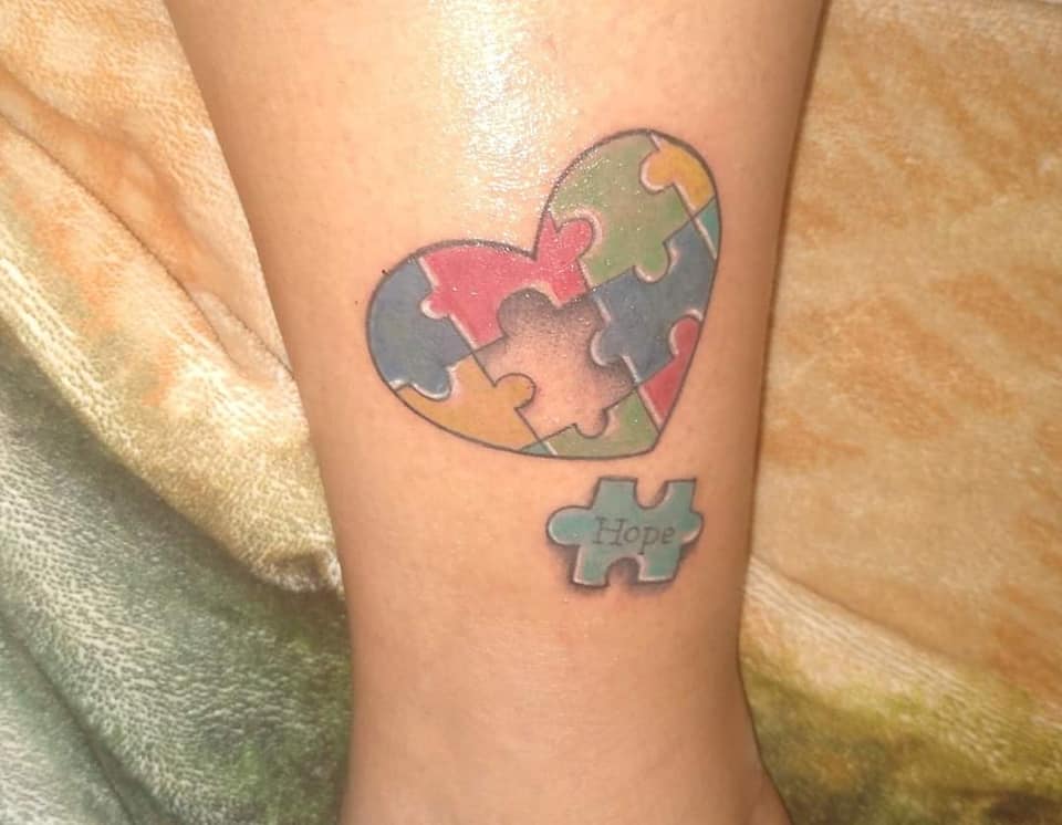 Most liked Women's tattoos July part 2 Heart-shaped puzzle representing a child with Autism with the word Hope Hope