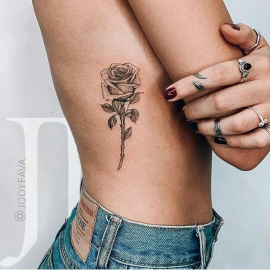 Tattoos of Flowers on the Ribs Black Rose Outline and shadows