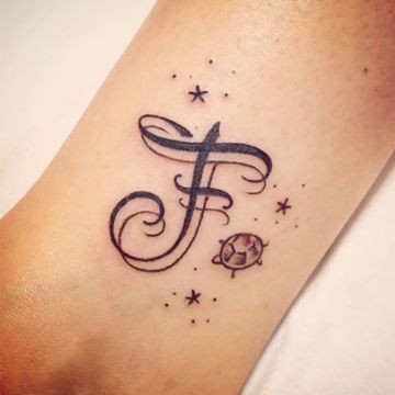 Tatuagens de Letras e Iniciais Letra F com espelho em traço mais fino como destaque tartaruga pequena e estrelas