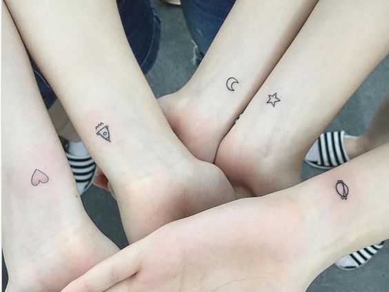 Tatuaggi per cinque amici, sorelle, cugini, un cuore, un razzo, una luna, una stella, Saturno sui polsi