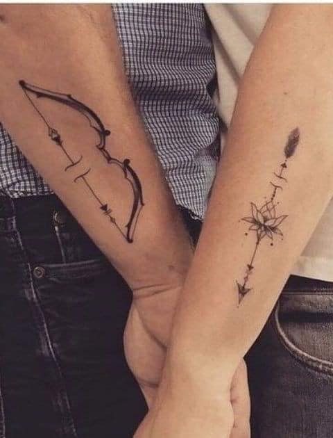 Tattoos for Couples of Characters and more Bow and Arrow with lotus flower on each forearm feather and geometric ornaments