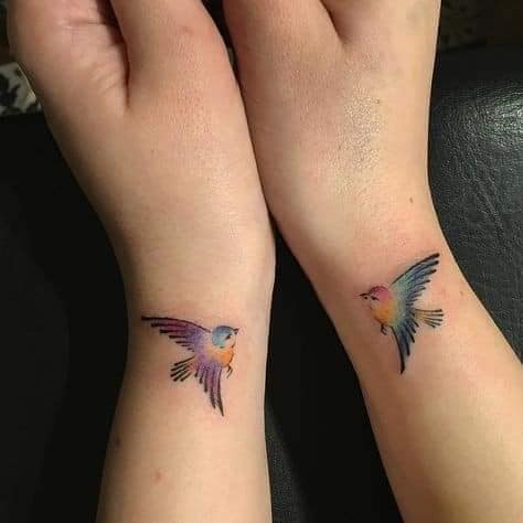 Tattoos for Couples of Characters and more Two swallows on each side of muneva in colors