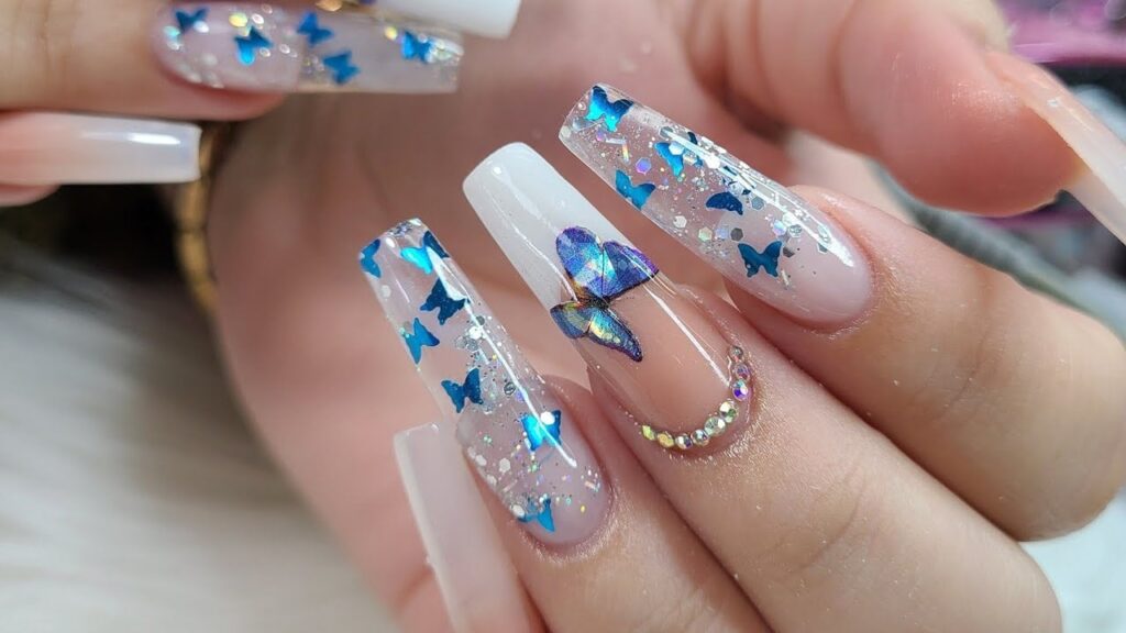 Some Transparent Acrylic Nails with Inlays of Silver and Gold Celestial Butterflies