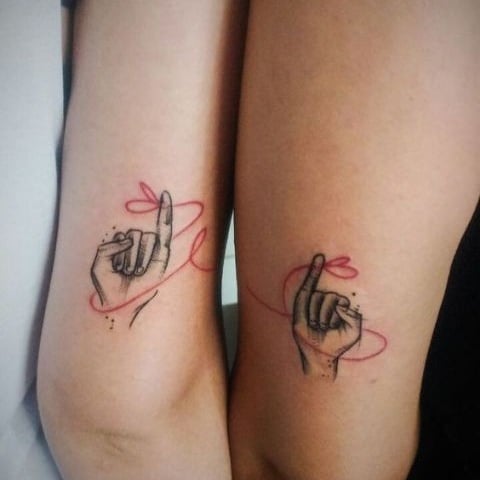 10 Tattoos for Best Friends on both arms hand with extended index finger red thread that joins the two and that passes from the arm of one to the arm of the other