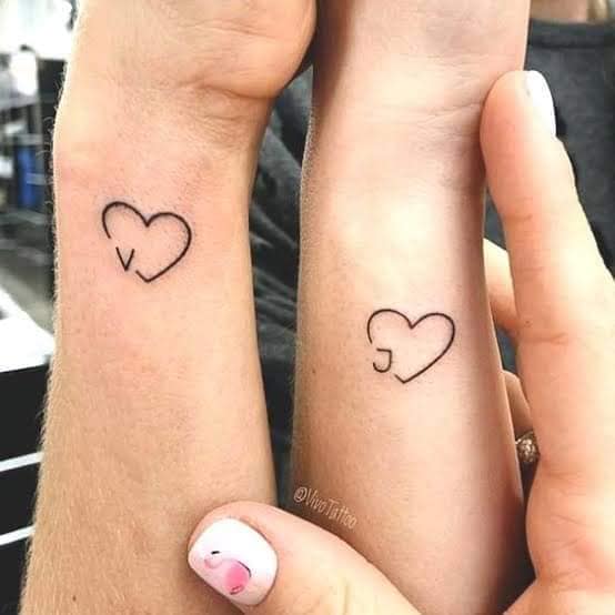 10 Tattoos for best friends two hearts with the initials V and J