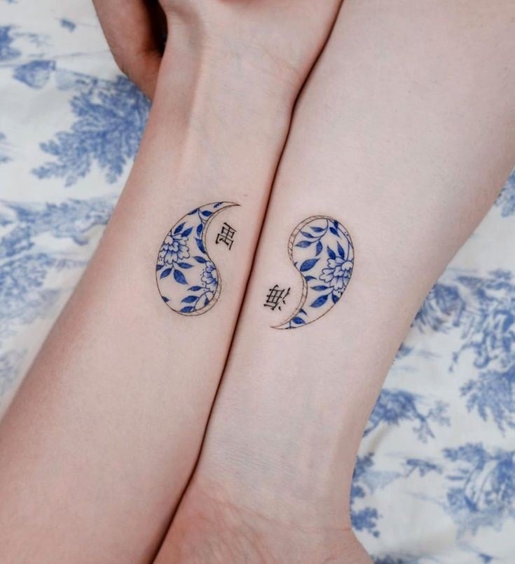 10 Blue Yin Yang Tattoos with black Chinese letters flower pattern inside paired on both arms