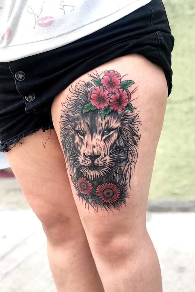 38 Original Tattoos Lion with red flowers on thigh