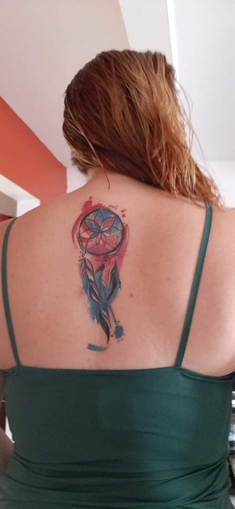52 Original Dreamcatcher Tattoos with Red Blue watercolor and feathers on the back between the shoulder blades