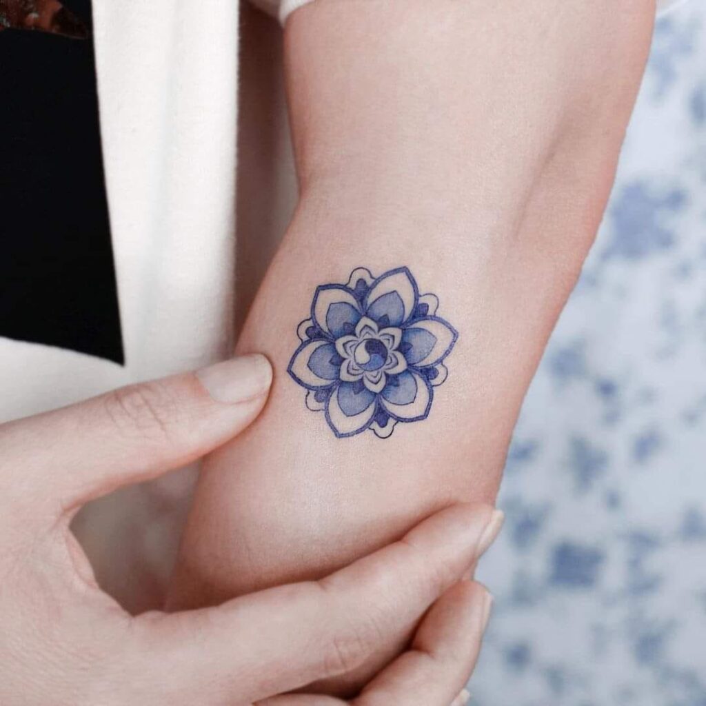 81 tatuagens com flor de lótus simétrica de tinta azul no braço