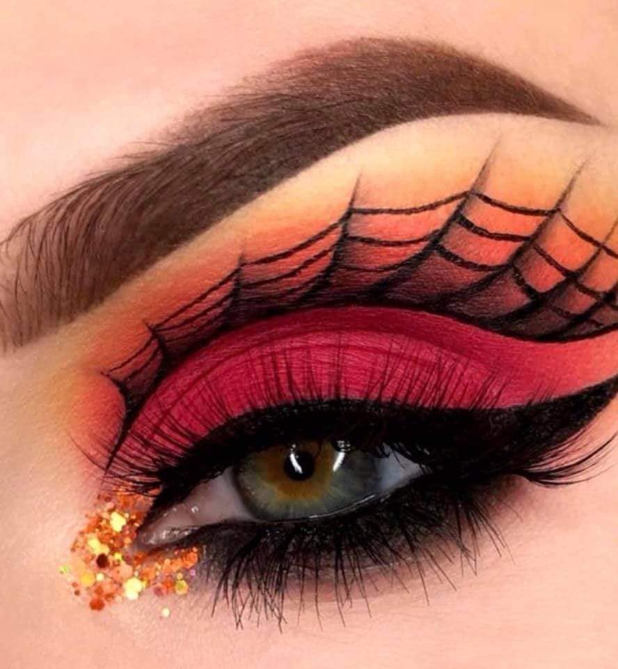 11 Halloween-Make-up-Spinnenstoff und fuchsiafarbene Augenlider mit gelb-orangefarbenem Glitzer