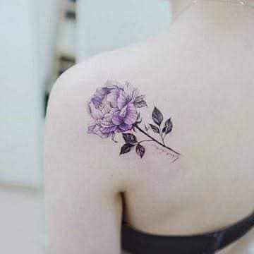 21 Female Tattoos Large Violet Flower and Green Stem on the shoulder blade
