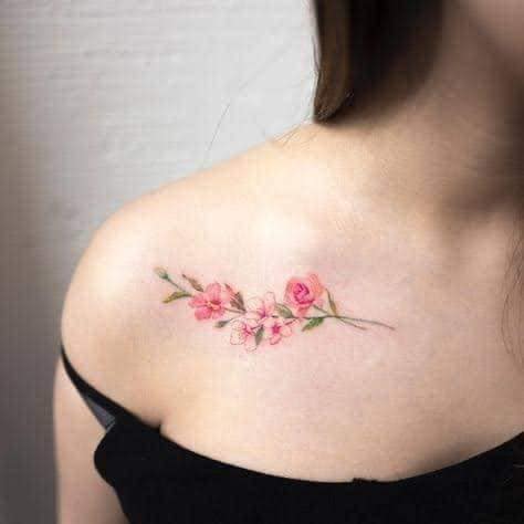 23 Female Tattoos of Cherry Blossoms on clavicle